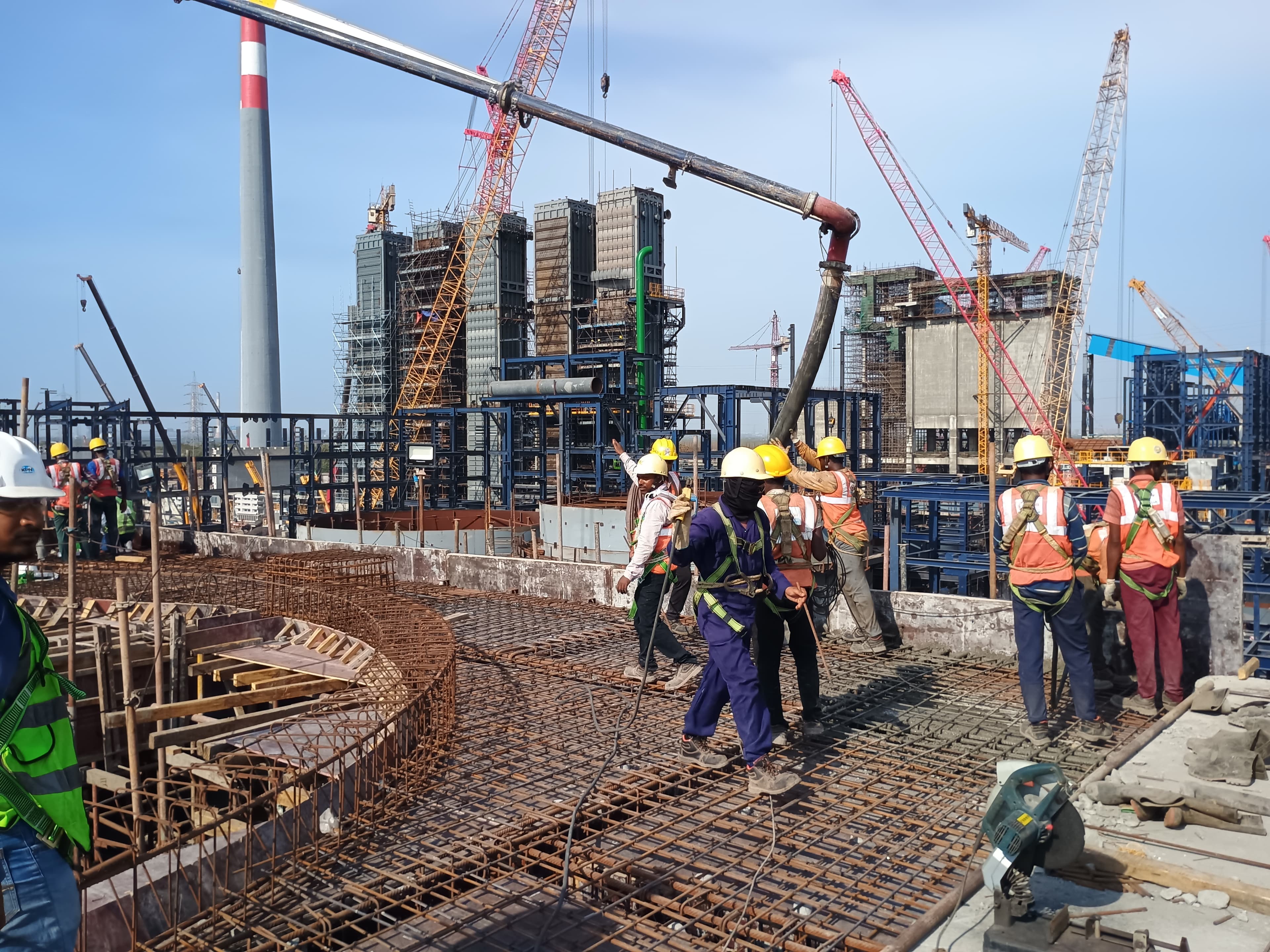 High-rise construction site with reinforced slab work and crew